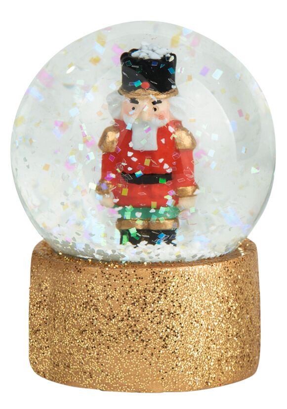 Glitzernde Schneekugel mit Nussknacker-Figur und goldenem Sockel, Marke: moses. Verlag.